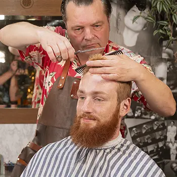 Barber trimming hair